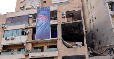 A banner depicting Hezbollah Secretary-General Hassan Nasrallah hangs on the building that hit by a drone attack, killing Hamas No. 2, Beirut, Lebanon, Jan. 2, 2024. (AFP Photo)