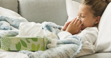 A girl wiping her nose amid a cold, Jan. 8, 2023. (Getty Images)