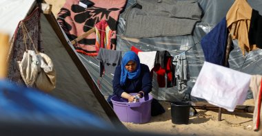 A displaced Palestinian woman, who fled her house due to Israeli strikes, shelters at a tent camp in Rafah in the southern Gaza Strip, Palestine, Jan. 8, 2024. (Reuters Photo)