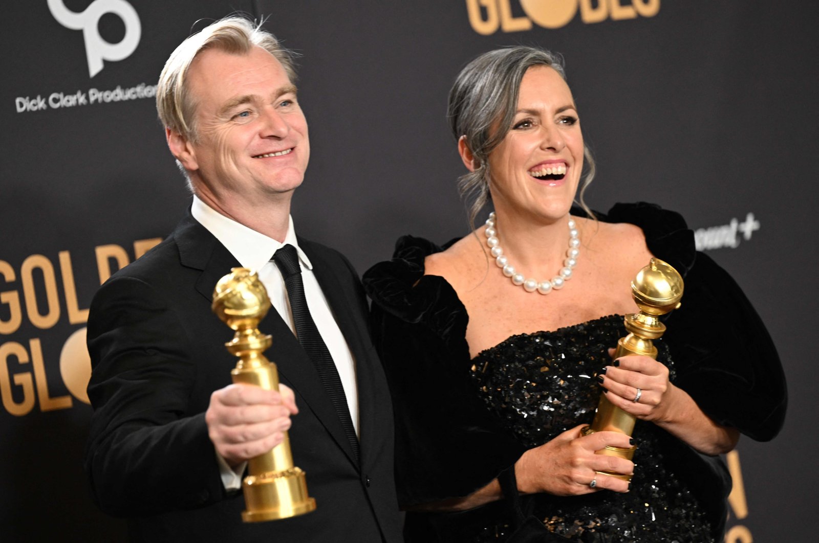 British director Christopher Nolan (L) and spouse British film producer Emma Thomas pose in the press room with the awards for Best Director - Motion Picture and Best Motion Picture - Drama for &quot;Oppenheimer&quot; during the 81st annual Golden Globe Awards, Beverly Hills, California, U.S., Jan. 7, 2024. (AFP Photo)