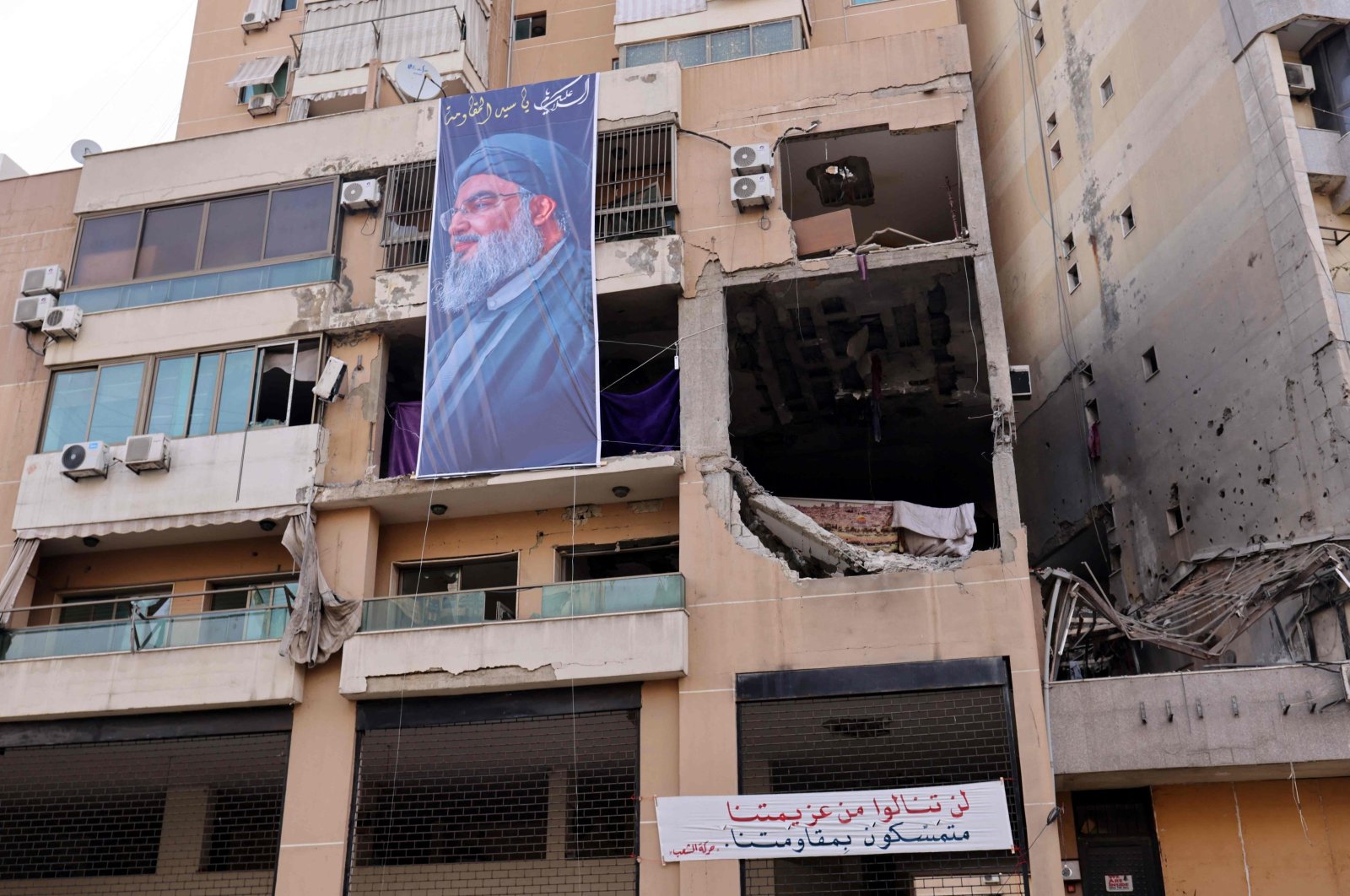 A banner depicting Hezbollah Secretary-General Hassan Nasrallah hangs on the building that hit by a drone attack, killing Hamas No. 2, Beirut, Lebanon, Jan. 2, 2024. (AFP Photo)