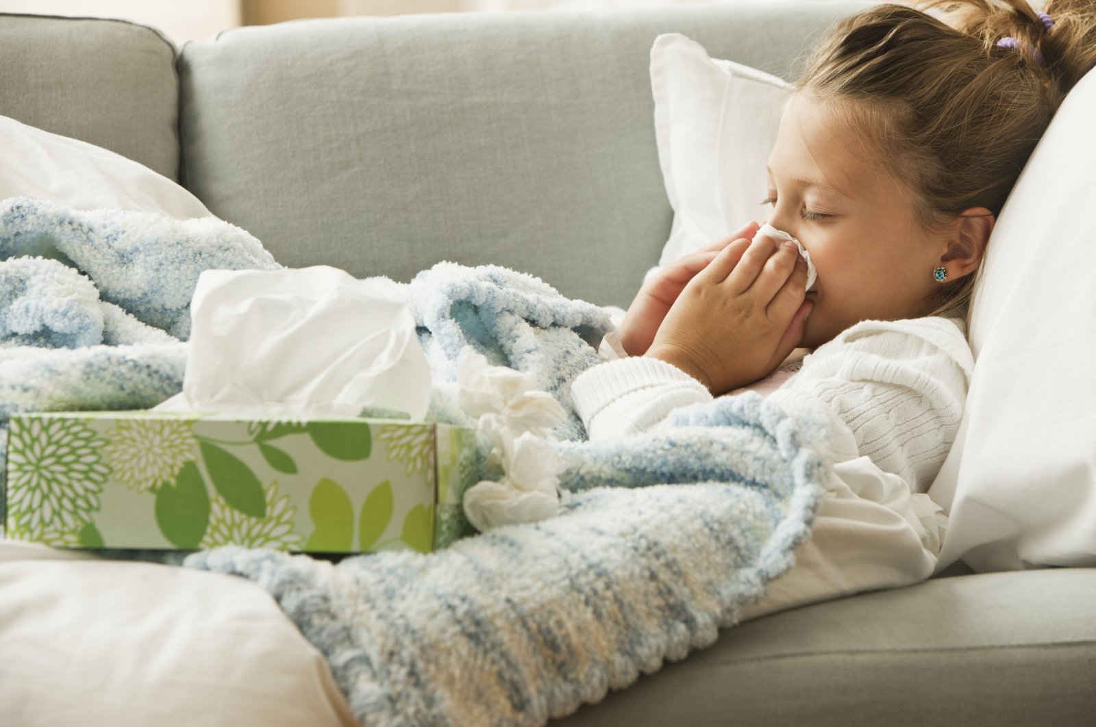 A girl wiping her nose amid a cold, Jan. 8, 2023. (Getty Images)