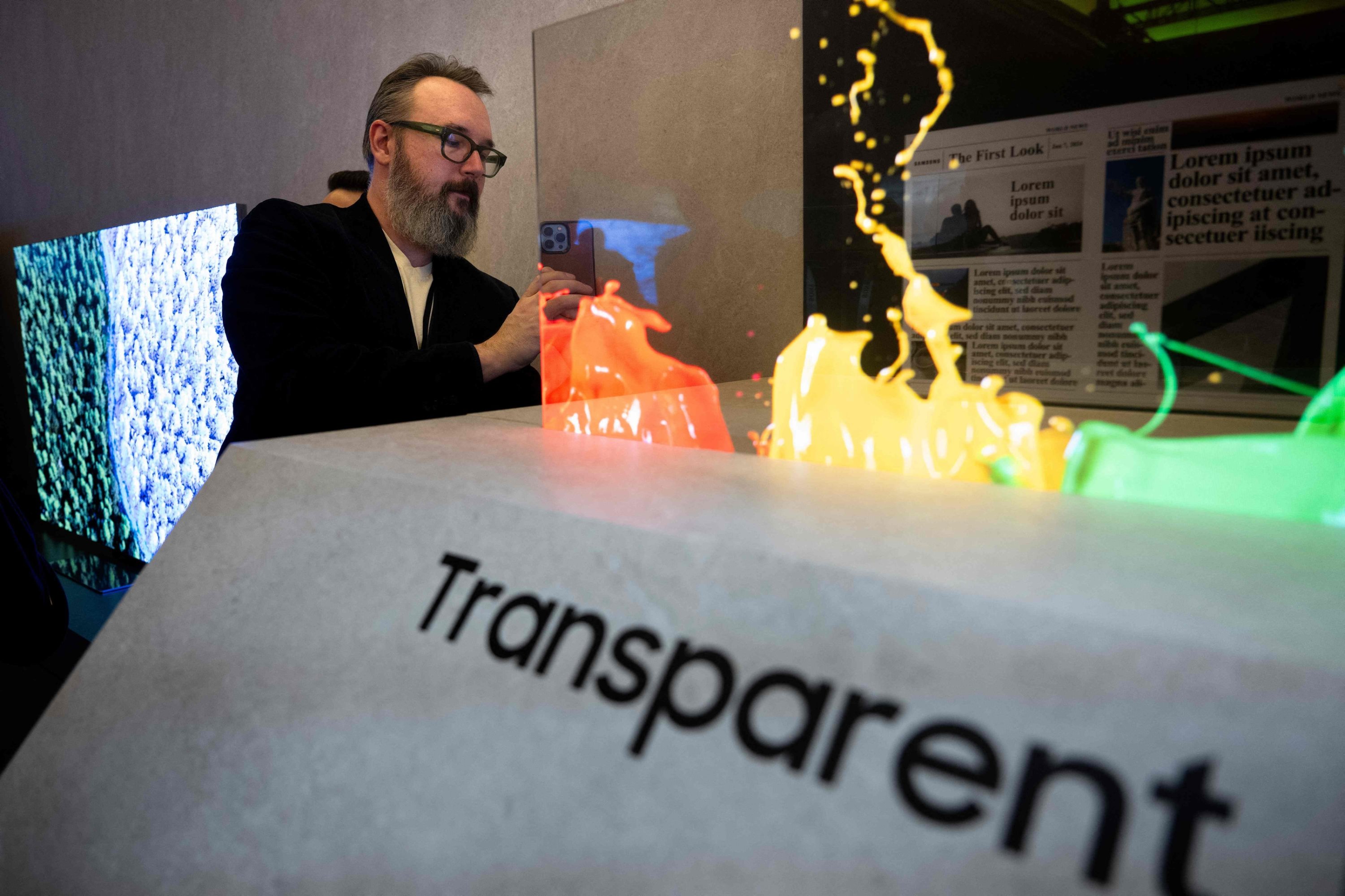 A person looks at a transparent microled screen during the Samsung First Look preview at the Caesars Palace Resort a pre-show for this week's Consumer Electronics Show (CES), in Las Vegas, Nevada, U.S., Jan. 7, 2024. (AFP Photo)