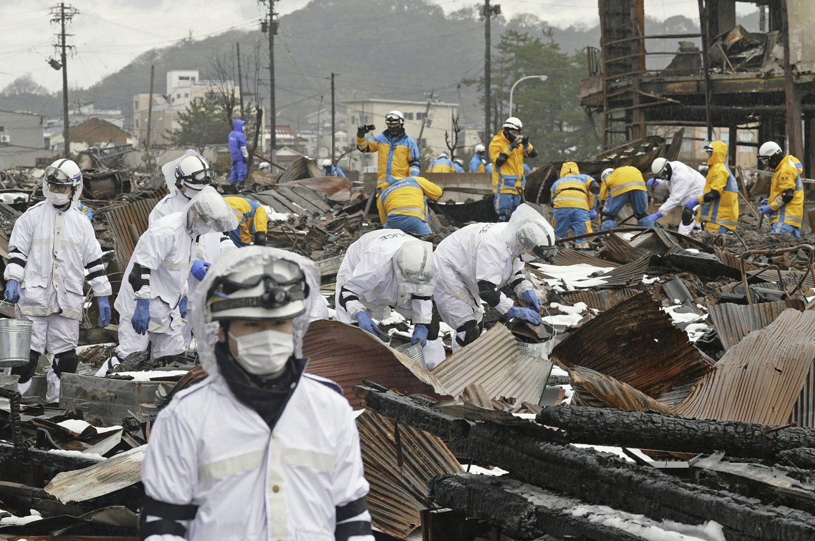Emergency workers conduct a search operation in Wajima, Ishikawa prefecture, Japan, Jan. 9, 2024. (AP Photo)