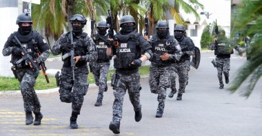 An Ecuadorean police squad enters the premises of Ecuador's TC television channel, Guayaquil, Ecuador, Jan. 9, 2024. (AFP Photo)