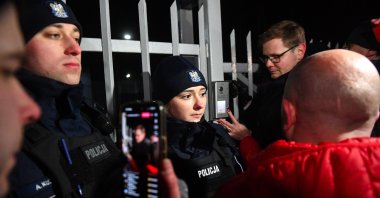 Police officers stand guard as opposition supporters protest against the detention of two former ministers in Warsaw, Poland, Jan. 9, 2024. (EPA Photo)