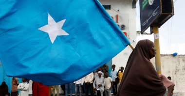 A Somali woman carries their flag during a march against the Ethiopia-Somaliland port deal along KM4 street in Mogadishu, Somalia, Jan. 11, 2024. (Reuters Photo)