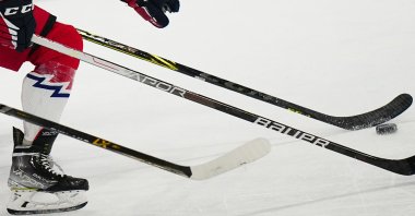 Players challenge for the puck during the quarterfinal match at the ice hockey world championship, Tampere, Finland, May 25, 2023. (AP Photo)