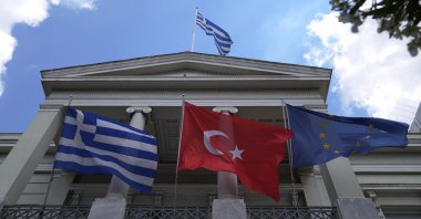 Greek, Turkish and European Union flags wave on the Foreign Ministry house before a meeting of then-Greek Foreign Minister Nikos Dendias and his then-Turkish counterpart Mevlüt Çavuşoğlu, Athens, Greece, May 31, 2021. (AP File Photo)