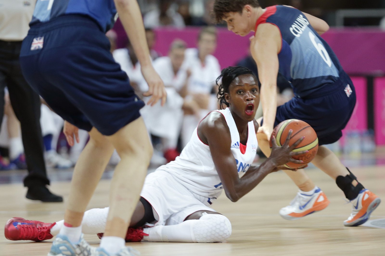 France&#039;s Emilie Gomis looks to pass as she is flanked by Britain&#039;s Stef Collins, right, and Natalie Stafford during a women&#039;s basketball game at the 2012 Summer Olympics, London, U.K., Aug. 3, 2012. (AP Photo)