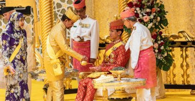 Brunei's Sultan Hassanal Bolkiah (2nd L) pouring scented oil on the hands of Prince Abdul Mateen during the royal powdering ceremony ahead of his wedding, Bandar Seri Begawan, Brunei, Jan. 10, 2024. (AFP Photo)