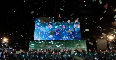 A display shows Taiwan's President-elect Lai Ching-te (L) and his running mate Hsiao Bi-khim attending a rally outside the headquarters of the Democratic Progressive Party (DPP) in Taipei on Jan. 13, 2024. (AFP Photo)
