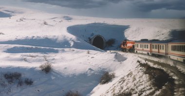 A scenic view of snow-covered mountains against the sky and Eastern Express train, Kars, Türkiye. (Getty Images Photo)
