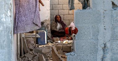 A woman sits in a damaged house following Israeli bombardment in Rafah, southern Gaza Strip, Palestine, Jan. 13, 2024. (AFP Photo)