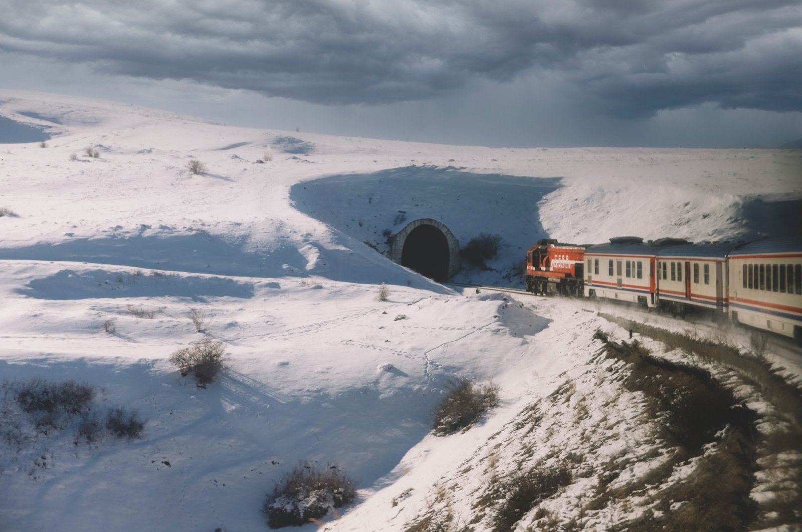 A scenic view of snow-covered mountains against the sky and Eastern Express train, Kars, Türkiye. (Getty Images Photo)
