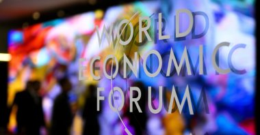 The logo of the World Economic Forum on a window of the Congress Center as participants and artificial intelligence-generated artwork by U.S.-based Turkish media artist Refik Anadol is reflected inside the center on the eve of the 54th annual meeting of the WEF in Davos, Switzerland, Jan. 14, 2024. (EPA Photo)