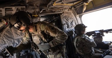 U.S. Army CH-47 Chinook helicopter gunners scan the desert over northeastern Syria, May 26, 2021. (Getty Images)