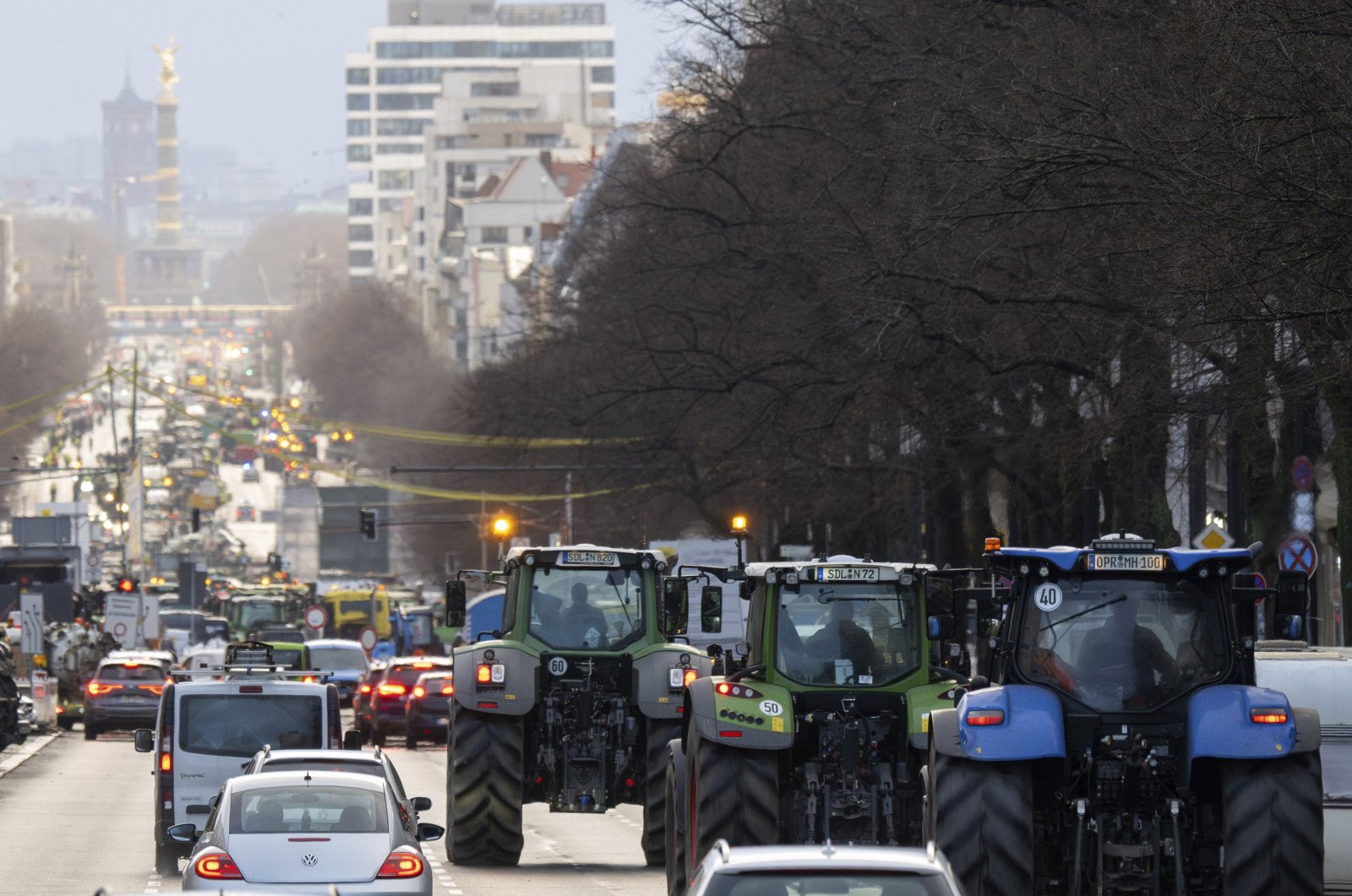 Tractors, trucks and cars drive along Kaiserdamm toward the Victory Column during a demonstration, Berlin, Germany, Jan. 15, 2024. (AP Photo)