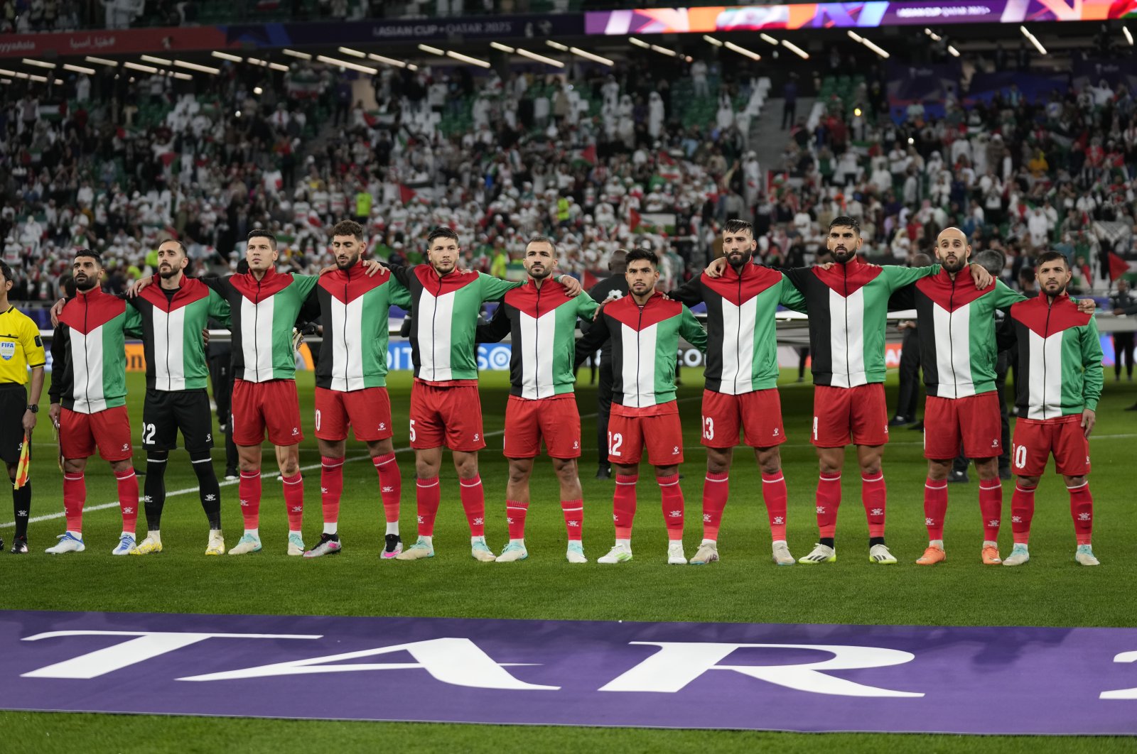The Palestinian team stands for the national anthem ahead of the Asian Cup Group C soccer match between Iran and Palestine at the Education City Stadium in Al Rayyan, Qatar, Jan. 14, 2024. (AP Photo)