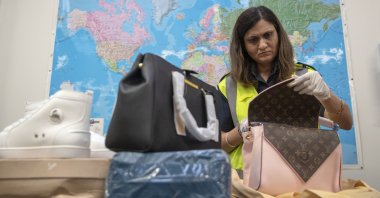 A Border Force officer uses an x-ray machine to search through mail for counterfeit items, at a facility near Slough, Berkshire, U.K., Nov. 28, 2018. (Reuters Photo)