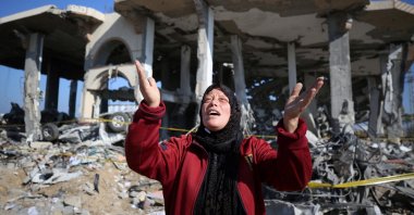 A Palestinian woman reacts in front of a destroyed building in the al-Maghazi refugee camp in central Gaza, Palestine, Jan. 16, 2024. (AFP Photo)