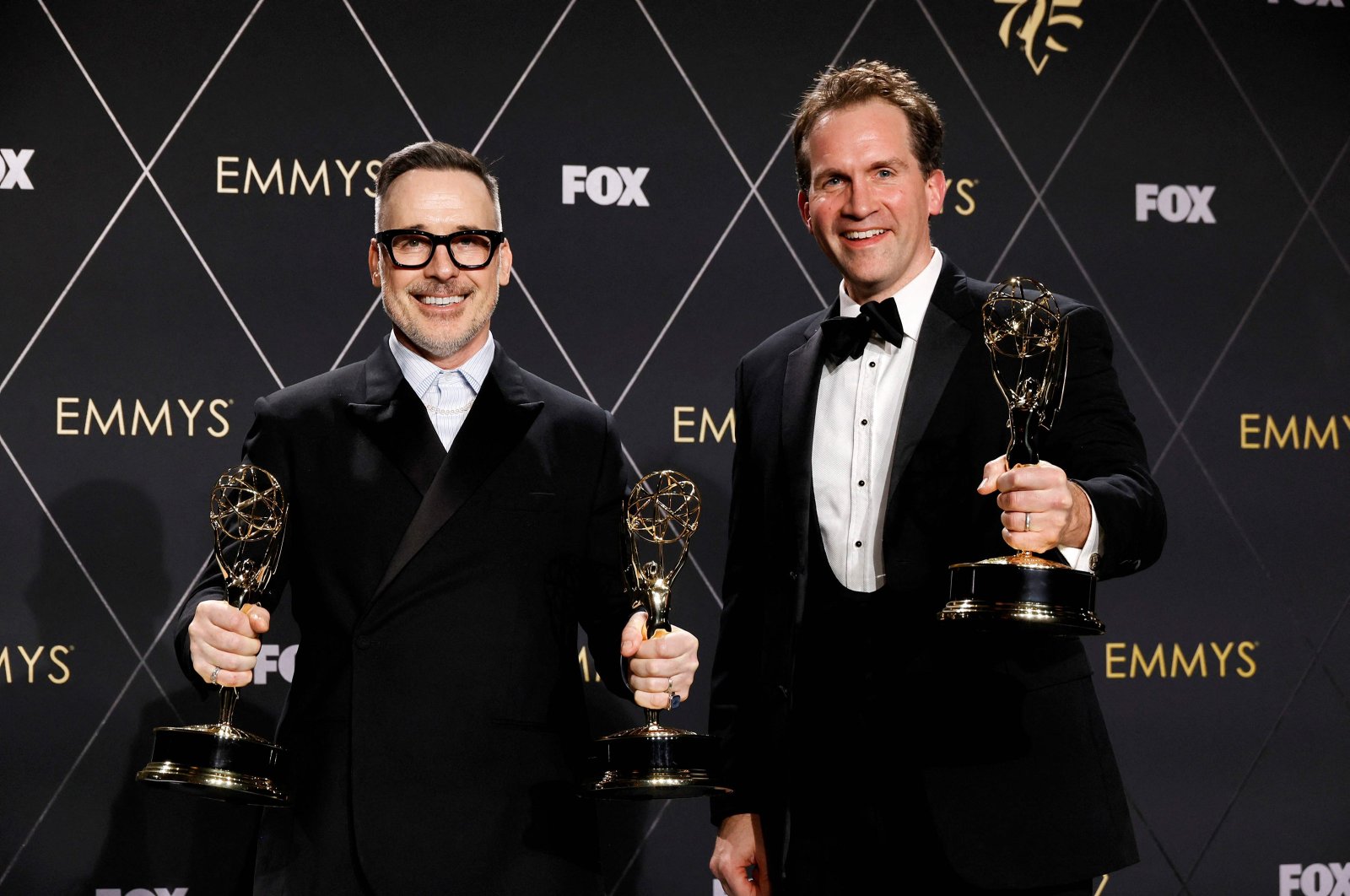 David Furnish (L) and Luke Lloyd Davies, winners of Outstanding Variety Special (Live) for &quot;Elton John Live: Farewell From Dodger Stadium,&quot; at the 75th Primetime Emmy Awards at Peacock Theater, Los Angeles, California, U.S., Jan. 15, 2024. (AFP Photo)