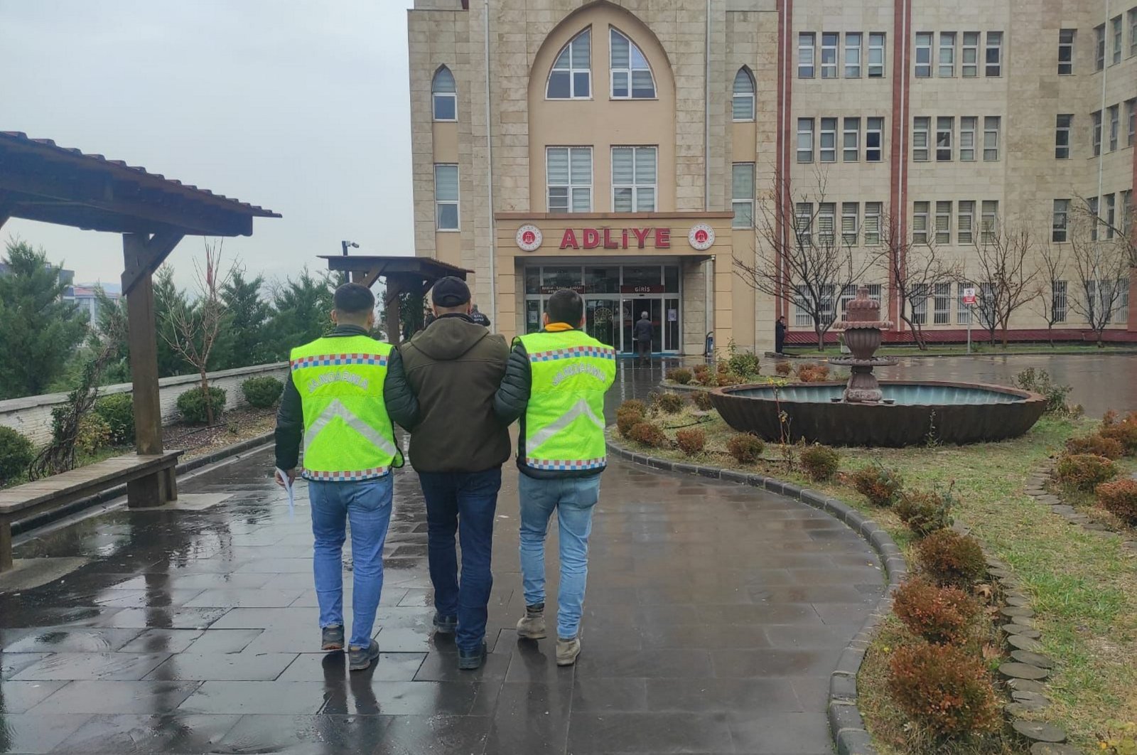 Two gendarmerie officers escort a fugitive FETÖ terrorist to the courthouse in the eastern Kahramanmaraş province, Türkiye, Jan. 12, 2024. (AA Photo)