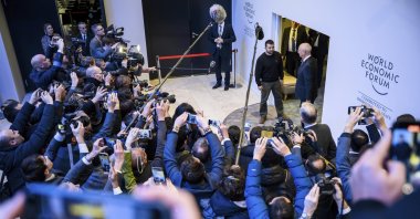 Ukrainian President Volodymyr Zelenskyy stands next to World Economic Forum Founder and Executive Chairman Klaus Schwab in front of the media during the 54th annual meeting of the WEF in Davos, Switzerland, Jan. 16, 2024. (AP Photo)