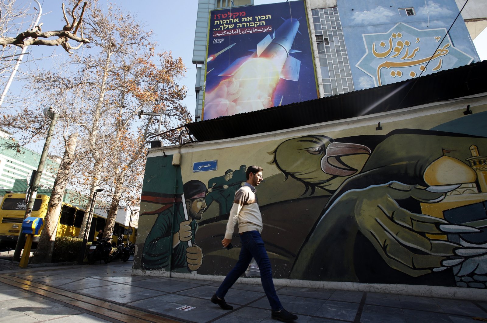 An Iranian man walks past a billboard depicting Iranian missiles in Tehran, Iran, Jan. 16, 2024. (EPA Photo)