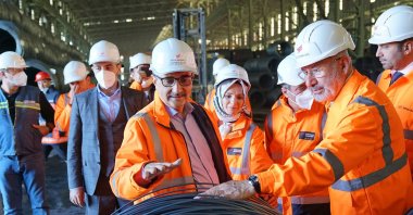 Fuat Tosyalı, chairperson of the board of directors of Tosyalı Holding (right) with Türkiye's then-ambassador to Algeria Mahinur Özdemir Göktaş (center) and then-Energy and Natural Resources Minister Fatih Dönmez at the company's factory in Algeria in this undated file photo from 2019. (Tosyalı Steel Website Photo)