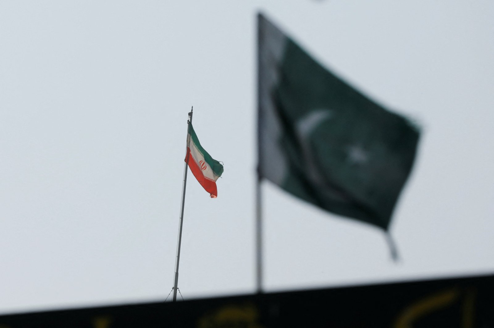 The flag of Iran is seen over its consulate building, with Pakistan&#039;s flag in the foreground, in Karachi, Pakistan, Jan. 18, 2024. (Reuters Photo)