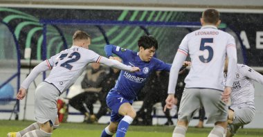 Istanbul Başakşehir's Eden Karzev (L) fights for the ball with Gent's Hyunseok Hong (C) during the Europa Conference League round of 16 first leg match at KAA Gent stadium, Ghent, Belgium, March 9, 2023. (AP Photo)