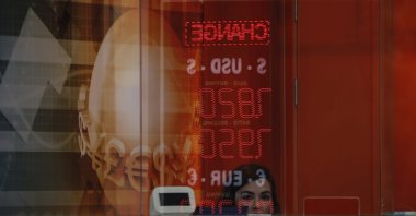 A worker in a currency exchange shop in Istiklal Avenue, the main shopping street in Istanbul, waits for customers, Istanbul, Türkiye, Oct. 9, 2020. (AP Photo)