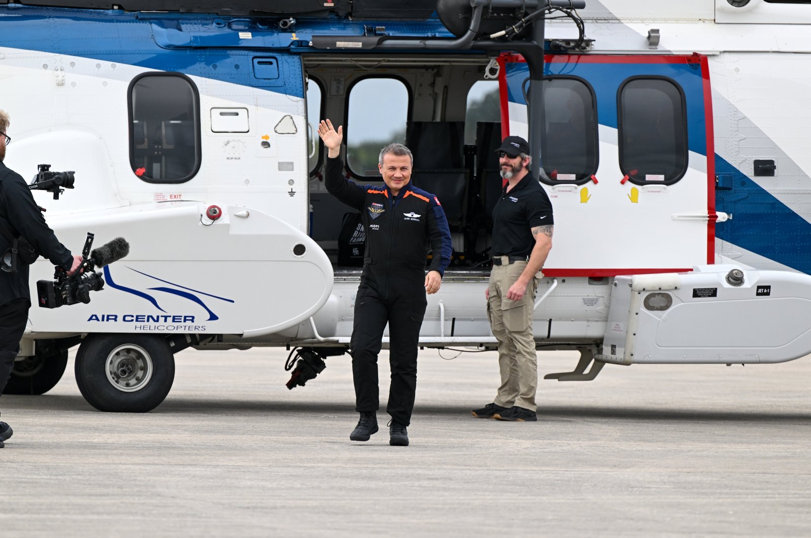 Türkiye&#039;s first space traveler Alper Gezeravcı waves to family members as he arrives at the Kennedy Space Center, Florida, the U.S., Jan. 18, 2023. (AA Photo)