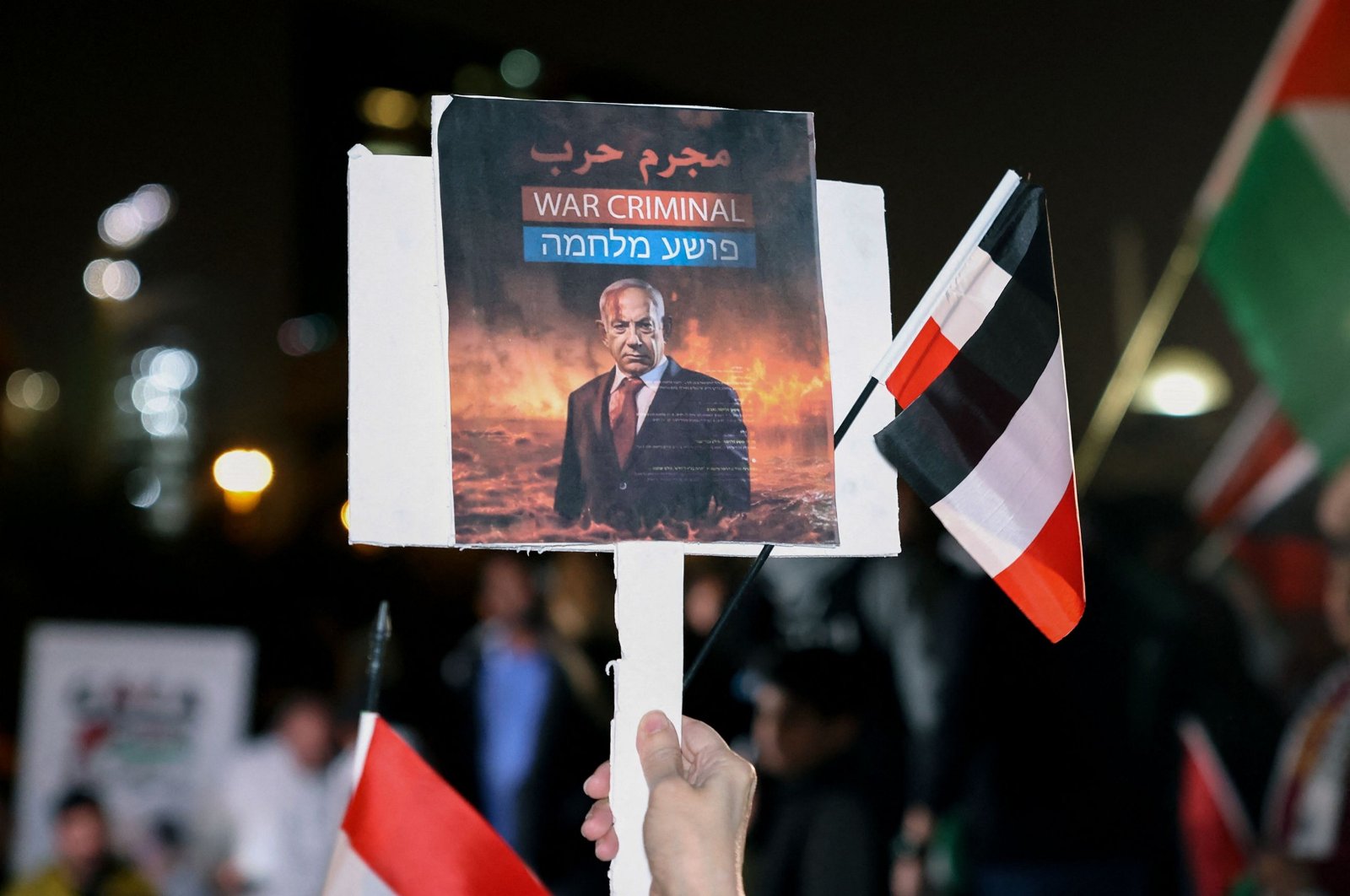 A man holds a placard of Israeli Prime Minister Benjamin Netanyahu during a rally in solidarity with Palestinians, Kuwait City, Kuwait, Jan. 14, 2024. (AFP Photo)