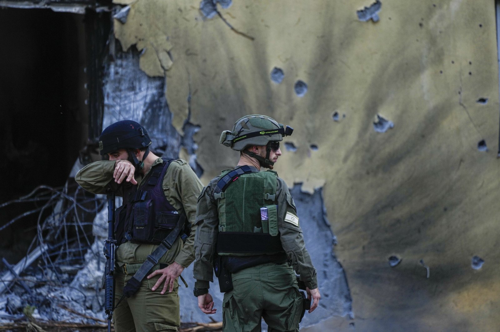Israeli soldiers walk past damaged houses in Kibbutz Be&#039;eri, Israel, Oct. 14, 2023. (AP Photo)