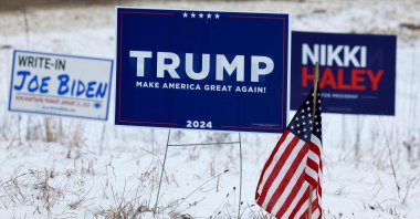 Campaign signs for Republican presidential candidates former President Donald Trump and former U.N. Ambassador Nikki Haley are next to a sign asking voters to write in President Joe Biden in primary elections in Loudon, New Hampshire, U.S., Jan. 19, 2024. (AFP Photo)