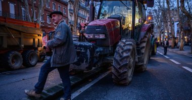 A farmer from the Midi-Pyrenees area of southwestern France prepares to leave with others in their tractors after a protest against taxation and declining income, in central Toulouse, France, Jan. 16, 2024. (AFP Photo)