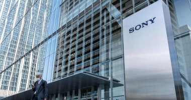 This file photo shows a man walking past the Sony logo outside the company's headquarters in Tokyo, Japan, Oct. 31, 2022. (AFP Photo)