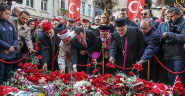 People leave flowers in memory of victims at the site of the Istiklal Street attack in Istanbul, Türkiye, Nov. 16, 2022. (AA Photo)