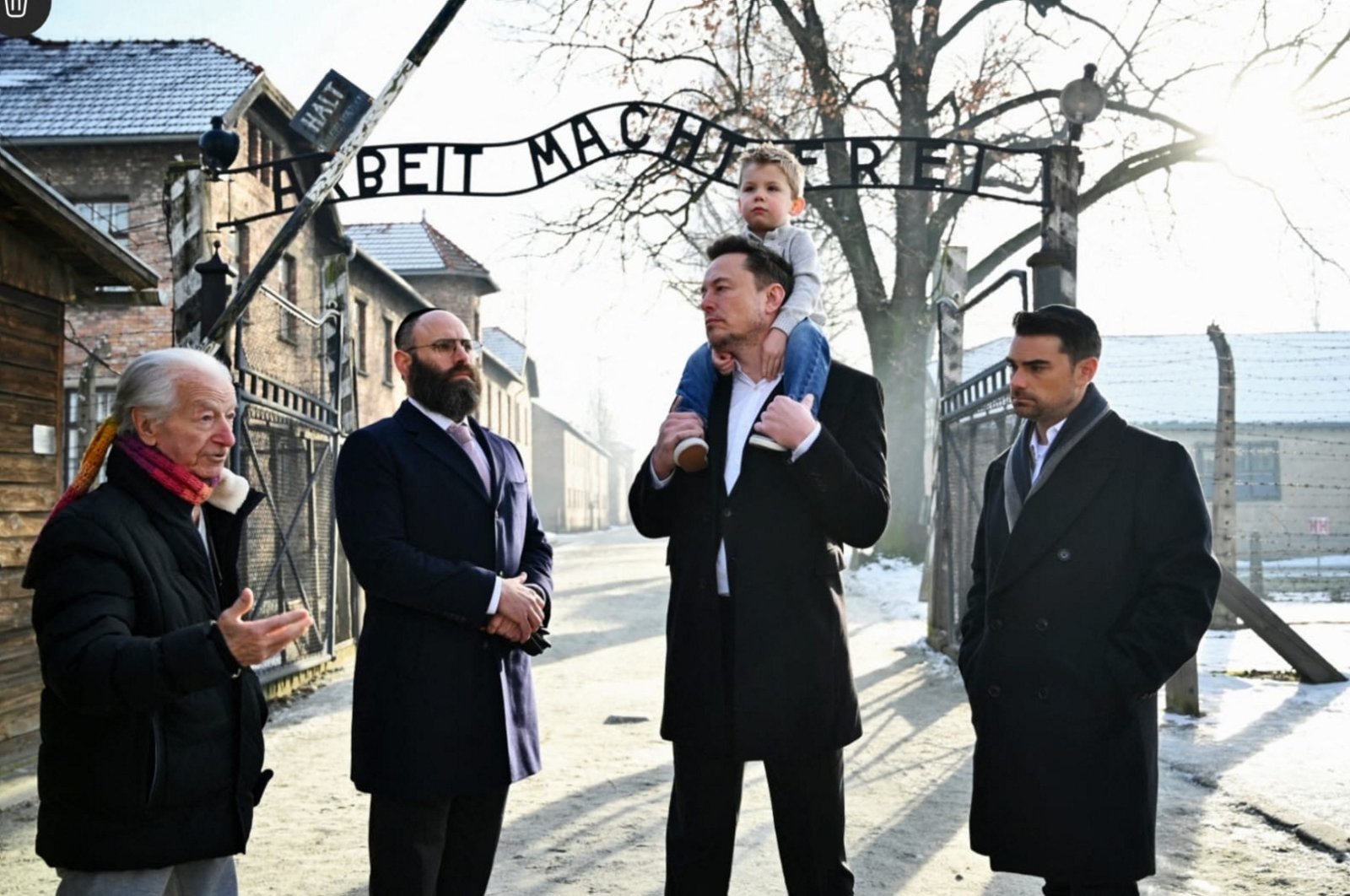 This handout picture released by the European Jewish Association shows X (formerly Twitter) CEO Elon Musk with his son (2R), EJA Chairman Rabbi Menachem Margolin (2L), Holocaust survivor Gidon Lev (L) and Conservative political commentator, writer and lawyer Ben Shapiro at the Memorial and Museum Auschwitz-Birkenau former German Nazi concentration and extermination camp during an EJA (European Jewish Association) Delegation to Auschwitz in Oswiecim, Poland on Jan. 22, 2024. (European Jewish Association via AFP)