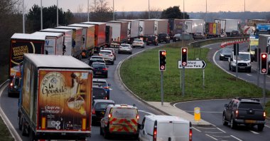 Trucks line up on the road leading to the Waterbrook Inland Border Facility, a temporary customs clearance center set up in a truck stop in Ashford, Kent, Britain, Jan. 15, 2021. (Reuters Photo)