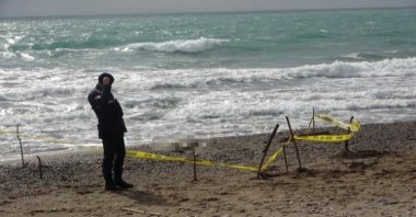 Authorities seal the beach after a body was washed ashore, Antalya, Türkiye, Jan. 21, 2024. (DHA Photo)