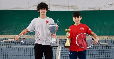 Turkish tennis players Emirhan Bulut (L) and his brother Talha Emin Bulut pose for a photo with their trophies at the Darıca Tennis Club, Kocaeli, Türkiye, Jan. 14, 2024. (AA Photo)