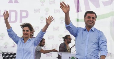 Selahattin Demirtaş (R), former co-chair of the pro-PKK People's Democratic Party (HDP) and his wife Başak Demirtaş (L) salute their supporters during a rally, May 30, 2015, in Istanbul, Türkiye. (Getty Images Photo)
