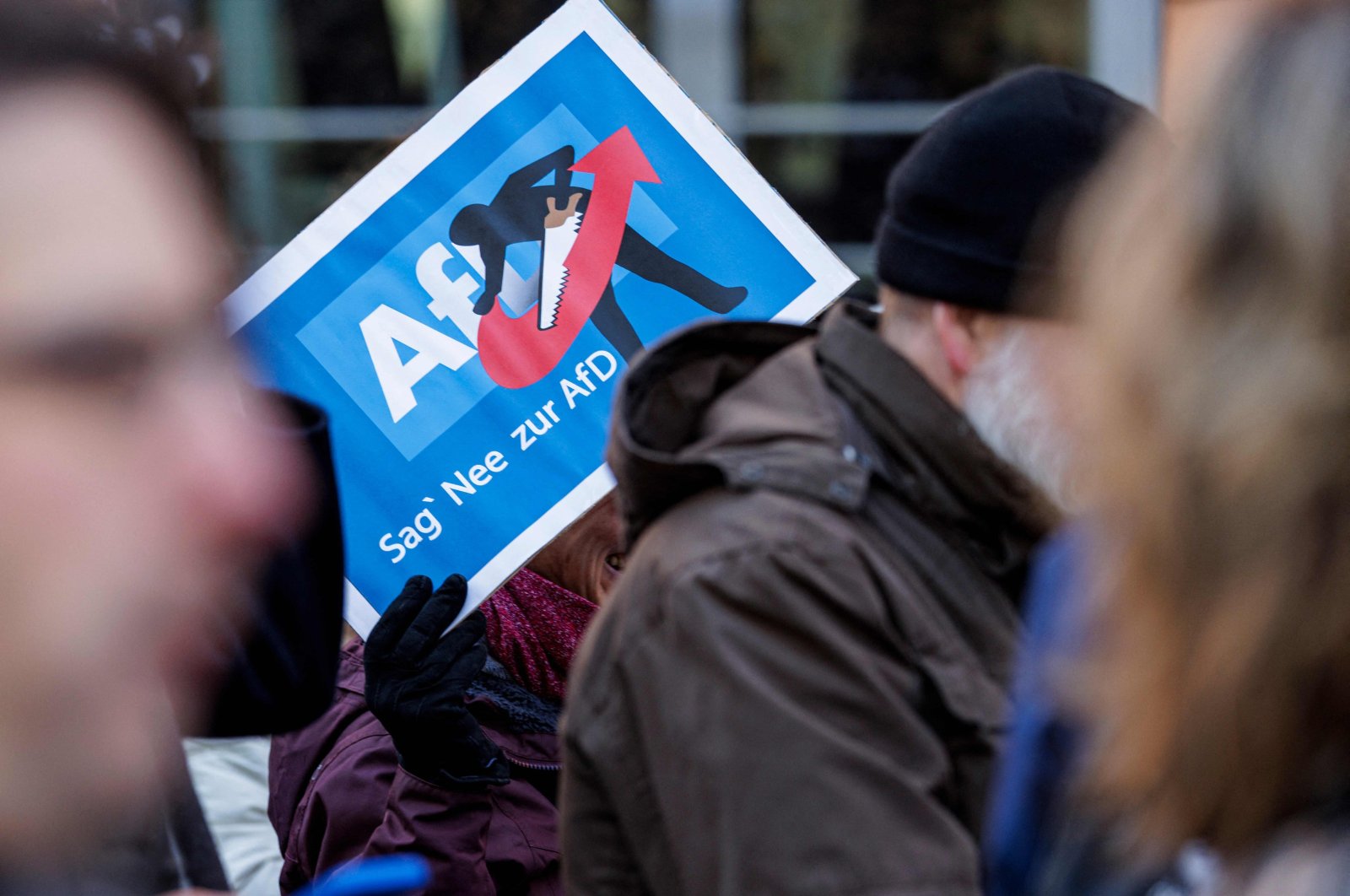 A person holds up a placard reading &quot;Say Nope to AFD&quot; as she takes part in a demonstration against racism and far-right politics, in Erfurt, eastern Germany on Jan. 20, 2024. (AFP Photo)