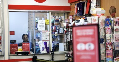 An employee sits inside a Post Office branch in London, Britain, Jan. 10, 2024. (EPA Photo)