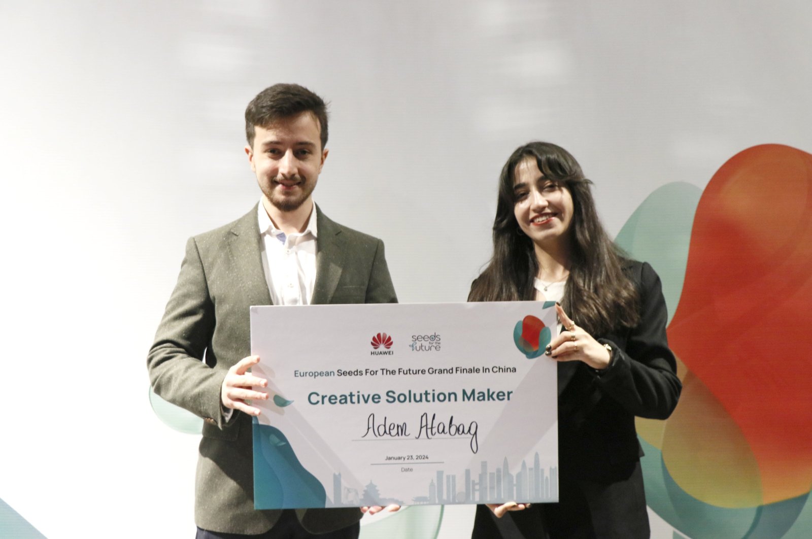 Turkish student Adem Atabağ (L) receives the &quot;Creative Solution Producer&quot; award, Beijing, China, Jan. 24, 2023. (AA Photo)