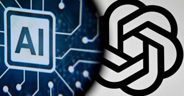 The logo of the ChatGPT application developed by U.S. artificial intelligence startup OpenAI on a laptop screen (R) and the letters AI on a smartphone screen in Frankfurt am Main, western Germany, Nov. 23, 2023. (AFP Photo)