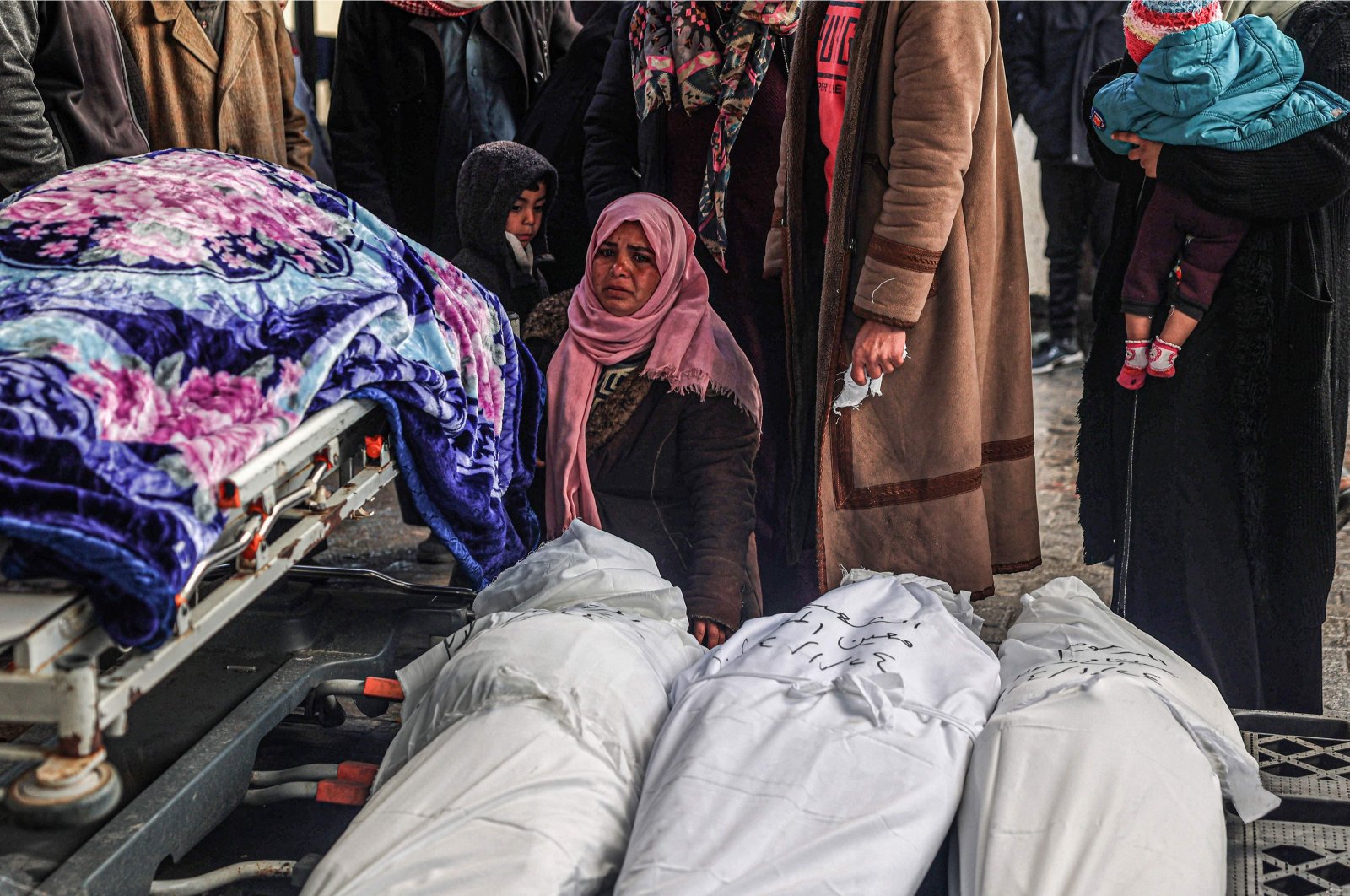 Palestinians mourn next to the bodies of relatives killed by Israeli bombardment in Rafah, the southern Gaza Strip, Palestine, Jan. 24, 2024. (AFP Photo)